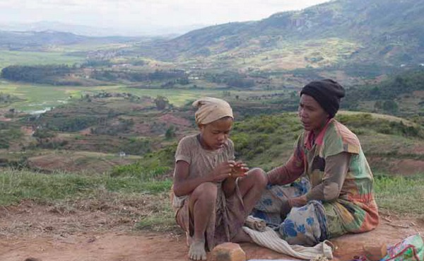photo de femme et enfant malgaches perches dans la campagne